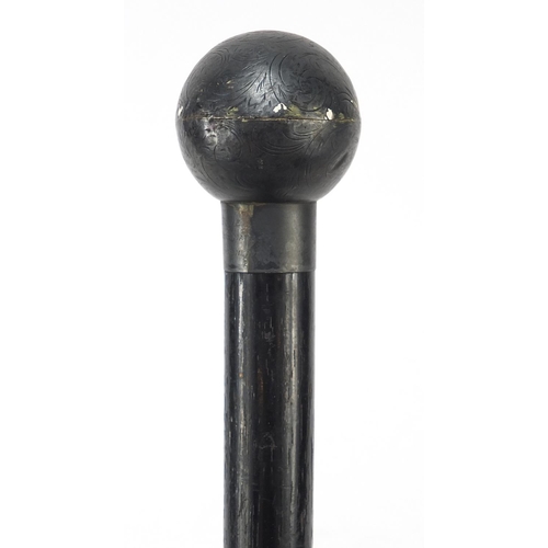 394 - Ebonised walking stick with globular floral chased silver pommel, London 1924, 89cm in length