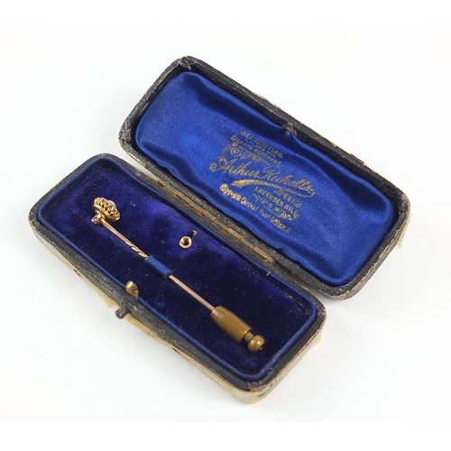 323 - Victorian unmarked gold, diamond and pearl tie pin with unmarked gold lapel mount, housed in a Arthu... 