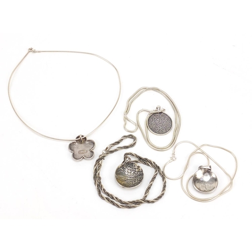 941 - Four silver pendants on silver necklaces including one mother of pearl, 75.2g