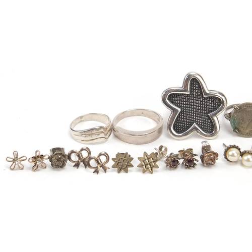 940 - Silver jewellery comprising five rings and fourteen pairs of earrings, total 63.2g