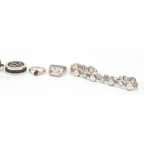 988 - Silver jewellery comprising nine rings set with stones and a pearl and cubic zirconia bracelet, 90.5... 