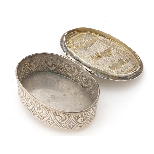 283 - Marston & Babyliss, Edward VII oval silver box, the hinged lid embossed with figures before a cathed... 