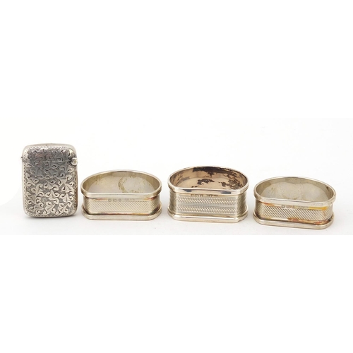 853 - Edward VII silver vesta and three silver napkin rings, the vesta Birmingham 1901, the largest 4.5cm ... 