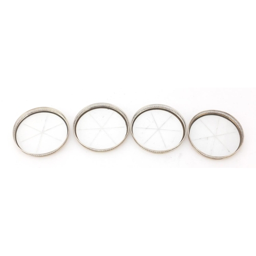 761 - Set of four circular sterling silver and glass coasters, 8cm in diameter