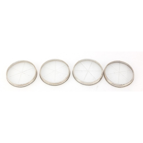 761 - Set of four circular sterling silver and glass coasters, 8cm in diameter