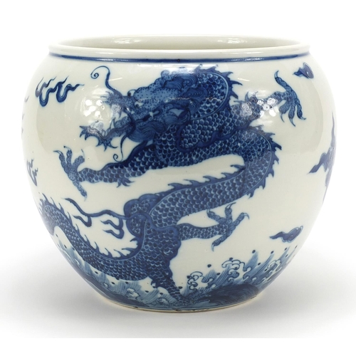 955 - Good Chinese blue and white porcelain jardinière hand painted with dragons chasing a flaming pearl a... 