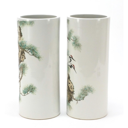 660 - Pair of Chinese porcelain cylindrical vases hand painted with cranes amongst pine trees, 28.5cm high