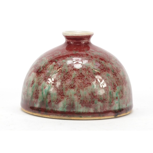 962 - Chinese porcelain beehive water pot having a sang de boeuf glaze, 9.5cm high