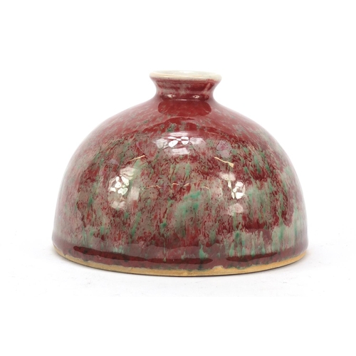 962 - Chinese porcelain beehive water pot having a sang de boeuf glaze, 9.5cm high