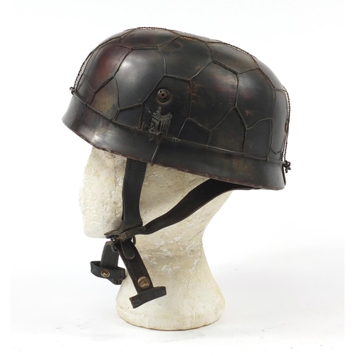 438 - German military interest Paratrooper type tin helmet with decal and leather liner