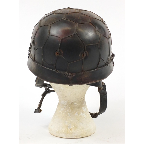 438 - German military interest Paratrooper type tin helmet with decal and leather liner