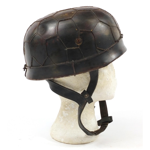 438 - German military interest Paratrooper type tin helmet with decal and leather liner