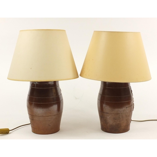 1920 - Pair of salt glaze barrel design table lamps with shades,  overall 53cm high