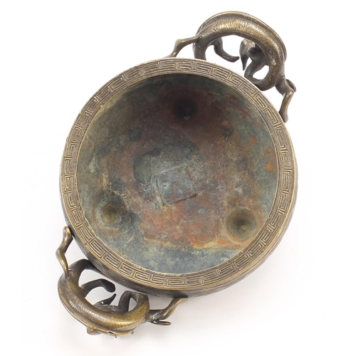 104 - Chinese patinated bronze tripod censer with twin dragon handles, four figure character marks to the ... 