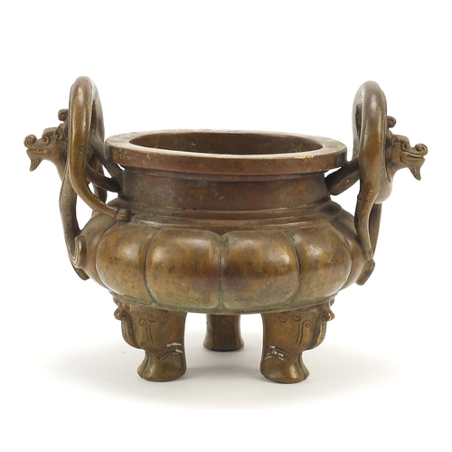 571 - Chinese patinated bronze tripod incense burner with twin dragon handles, six figure character marks ... 