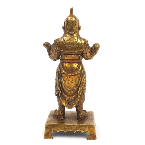 665 - Chino-Tibetan gilt bronze figure of a warrior, 23.5cm high