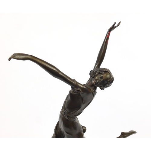 718 - Large patinated bronze figurine of an Art Deco dancer raised on a tapering marble and black slate ba... 