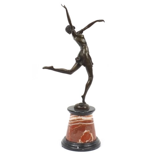 718 - Large patinated bronze figurine of an Art Deco dancer raised on a tapering marble and black slate ba... 