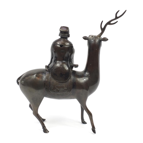 354 - Large Chinese patinated bronze incense burner in the form of a scholar seated on a deer, 33cm in len... 