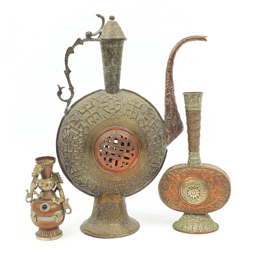 56 - Tibetan metalware including a large wine ewer and vase decorated in relief with two dragons and appl... 