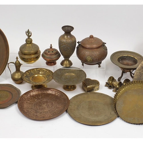 477 - Middle Eastern metalware including gong, trays and vases, mostly engraved and decorated with figures... 