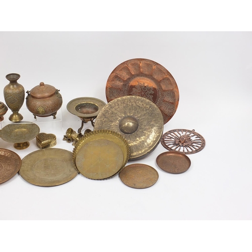 477 - Middle Eastern metalware including gong, trays and vases, mostly engraved and decorated with figures... 