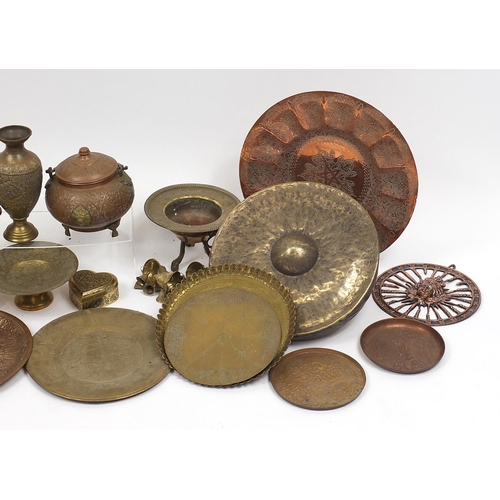 477 - Middle Eastern metalware including gong, trays and vases, mostly engraved and decorated with figures... 