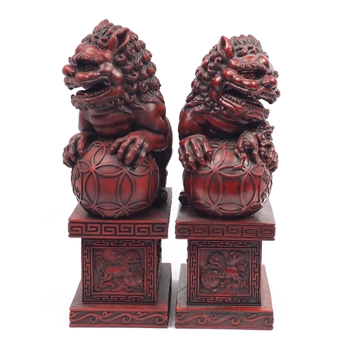 1190 - Large pair of Chinese red lacquered style Foo dogs, each 49.5cm high