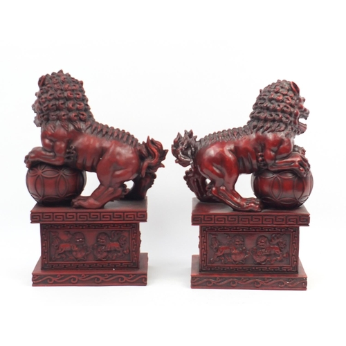 1190 - Large pair of Chinese red lacquered style Foo dogs, each 49.5cm high