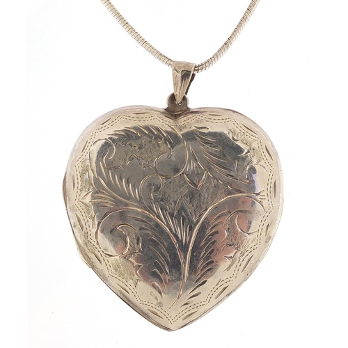 1036 - Large silver love heart locket engraved with foliage on a silver necklace, 6cm high and 36cm in leng... 