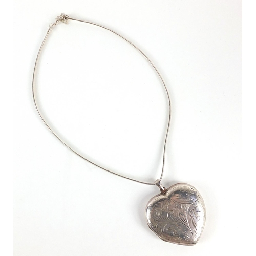 1036 - Large silver love heart locket engraved with foliage on a silver necklace, 6cm high and 36cm in leng... 