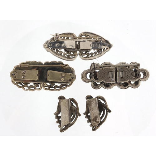 865 - Four silver coloured metal marcasite two piece clips, the largest 5.5cm wide