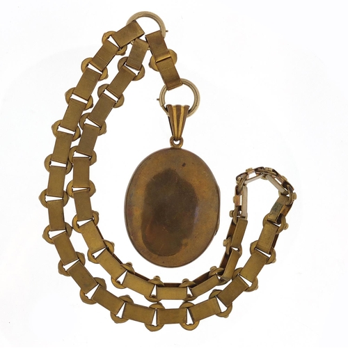 503 - Victorian aesthetic gilt metal locket on a gilt metal necklace, 6cm high and 40cm in length