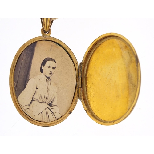 503 - Victorian aesthetic gilt metal locket on a gilt metal necklace, 6cm high and 40cm in length