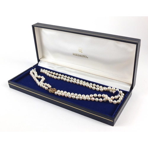 642 - Cultured pearl two row necklace with 9ct gold clasp, housed in a Mikimoto velvet and silk lined box,... 