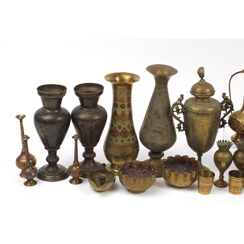 478 - Indian brass and metalware including serpent design sconces, engraved vases and a jug, the largest 3... 