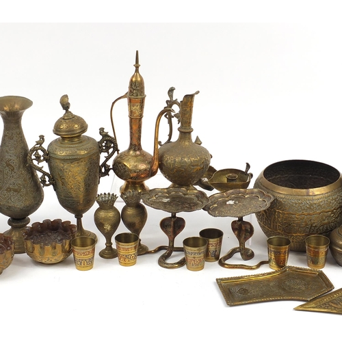 478 - Indian brass and metalware including serpent design sconces, engraved vases and a jug, the largest 3... 