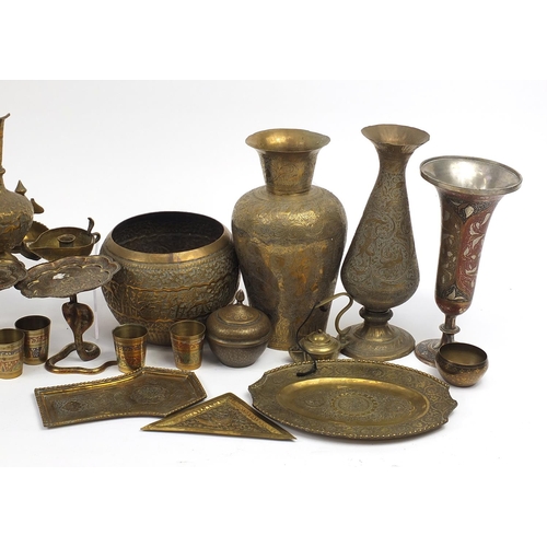 478 - Indian brass and metalware including serpent design sconces, engraved vases and a jug, the largest 3... 