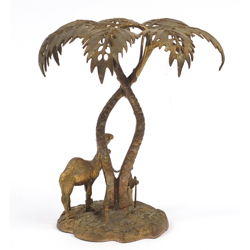 584 - Elkington & Co style gilt metal study of a figure with camel beneath a palm tree, 25.5cm high