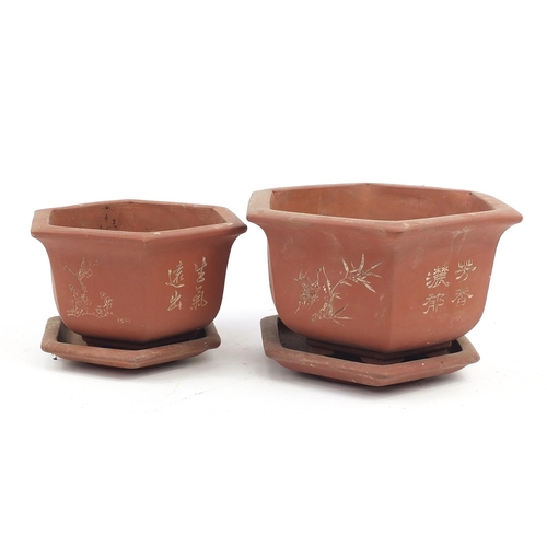 908 - Two Chinese Yixing terracotta hexagonal planters on stands decorated with calligraphy and trees, the... 