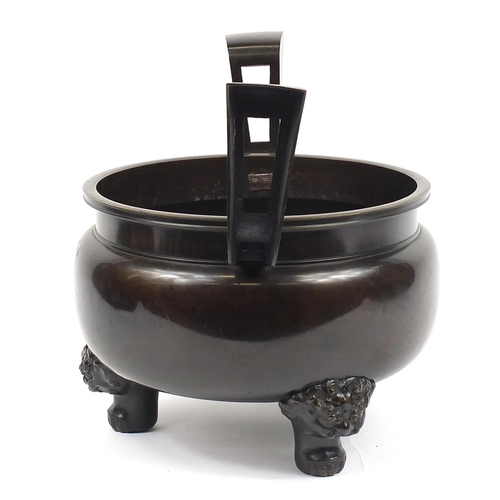 1180 - Large Japanese patinated bronze tripod censer with twin handles, 46.5cm high x 60cm wide