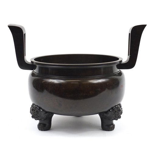 1180 - Large Japanese patinated bronze tripod censer with twin handles, 46.5cm high x 60cm wide