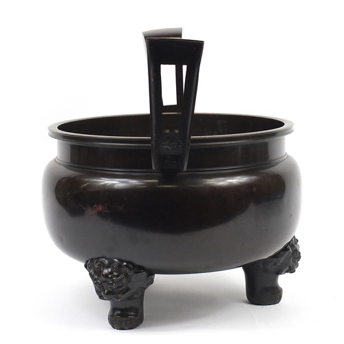 1180 - Large Japanese patinated bronze tripod censer with twin handles, 46.5cm high x 60cm wide