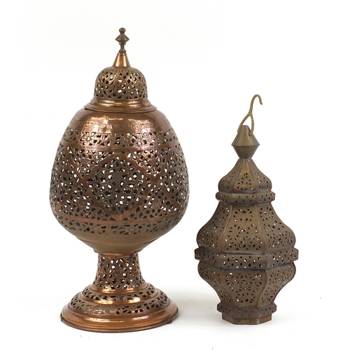 473 - Two Persian copper lanterns pierced and engraved with flowers, the largest 53cm high