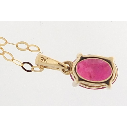 539 - 9ct gold ruby pendant on a 9ct gold necklace, 1.2cm high and 46cm in length, total 1.0g