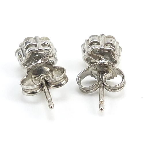 863 - Pair of silver diamond flower head stud earrings, 5.2mm in diameter, 0.9g