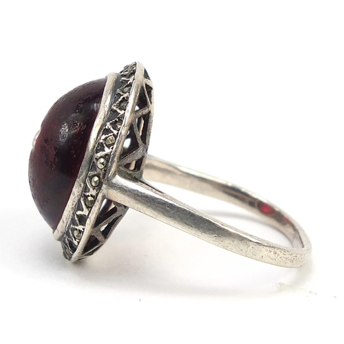 384 - Antique unmarked white metal marcasite and cabochon red stone ring set with a central seed pearl, si... 