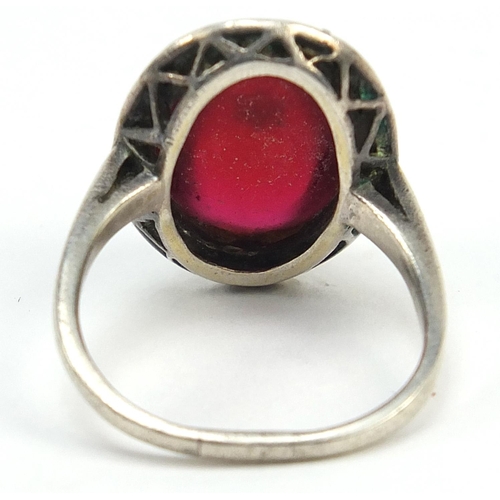 384 - Antique unmarked white metal marcasite and cabochon red stone ring set with a central seed pearl, si... 