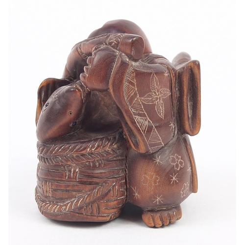 234 - Japanese carved wood netsuke of a fisherman, inset mother of pearl plaque with character marks to th... 