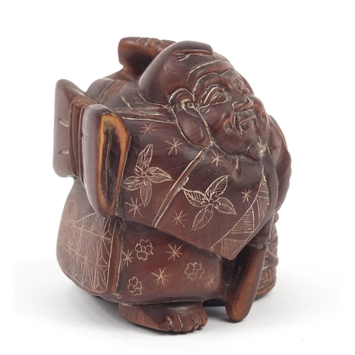 234 - Japanese carved wood netsuke of a fisherman, inset mother of pearl plaque with character marks to th... 